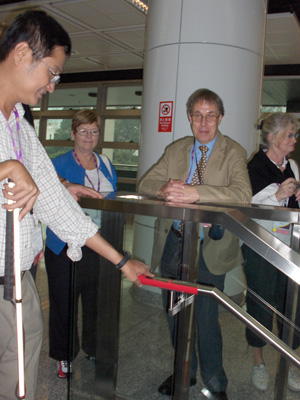 photo shows Le Dan Bach Viet with his hand on a red label on the end of the railing.