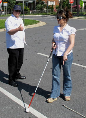 Photo shows Jomania walking to the end of the first lane and pointing to the marker, Paul gives her a 'thumbs-up'.