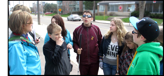 Both of these photos show the students and instructors standing in a circle near the street where the videos were taken, talking about their experience.
