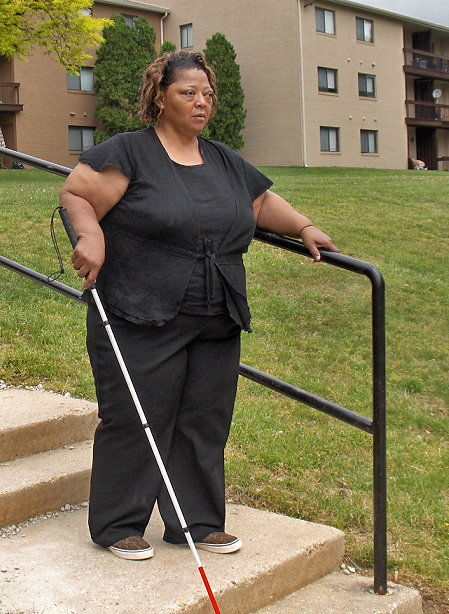 The woman is on the landing and approaching more steps ahead.  In this series, she is looking forward and standing straight in good posture.