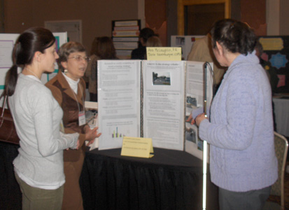 Dona and Ann show the poster to a woman.