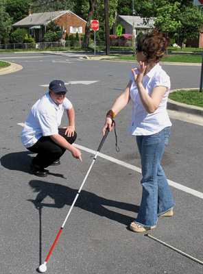 Photo shows them in the same positions, but the student is giving the sign for 'okay, I understand.