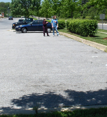 Photo shows Stephan and Dona standing at the lane marker, Dona is holding a stopwatch.
