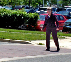 Photo shows Dona starting to walk across the street.